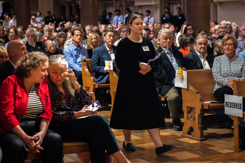 Medical student Anastasia Crenshaw carries flowers to the altar during the Interfaith Memorial Service for the Gift Body Program on Friday, Oct. 25, 2024. Photo by Sarah Conroy. 