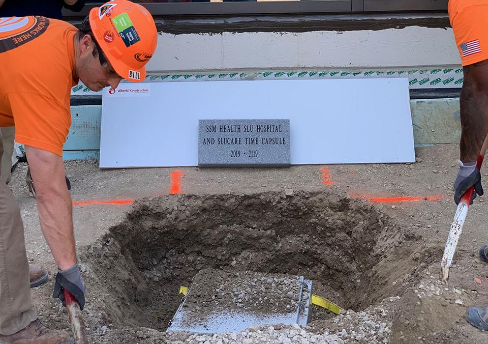 Construction workers bury the 100-year time capsule outside SSM Health Saint Louis University Hospital. Photo by Maggie Rotermund