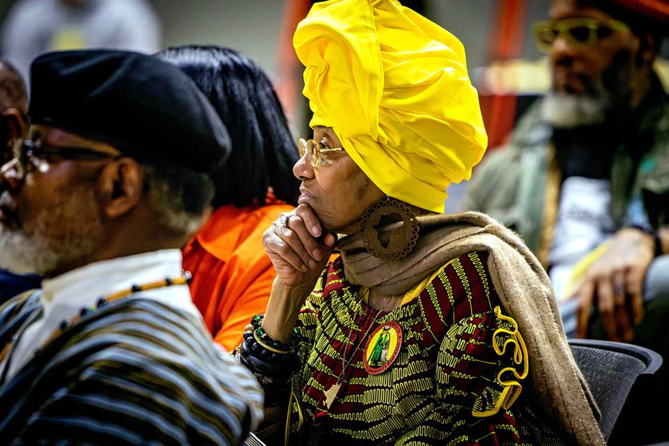 Descendant Mama Safiyah Chauvin, center, listens during the Lights of Remembrance Candlelight Vigil on Feb. 27, 2025. Photo by Sarah Conroy. 