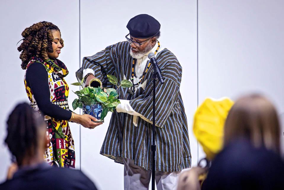 Poet InnerGy, left and Baba Seba Amari Sneferu, right, participate in the Libation Ceremony during the Lights of Remembrance Candlelight Vigil on Thursday, Feb. 27, 2025. Photo by Sarah Conroy. 
