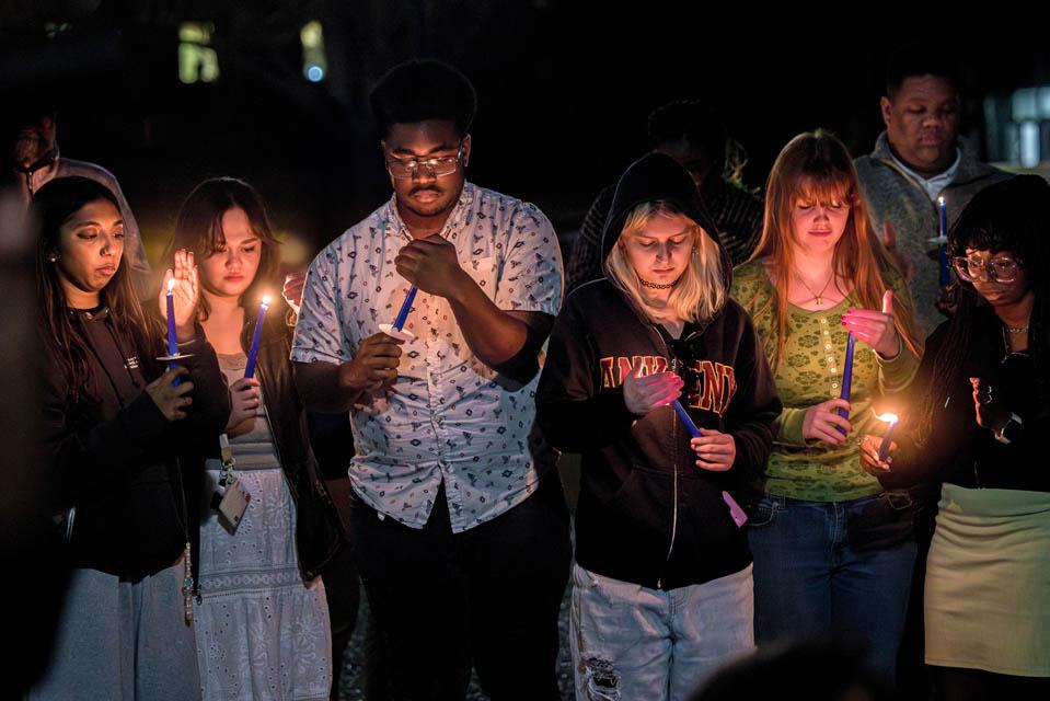Attendees light candles during the Lights of Remembrance Candlelight Vigil on Thursday, Feb. 27, 2025. Photo by Sarah Conroy. 