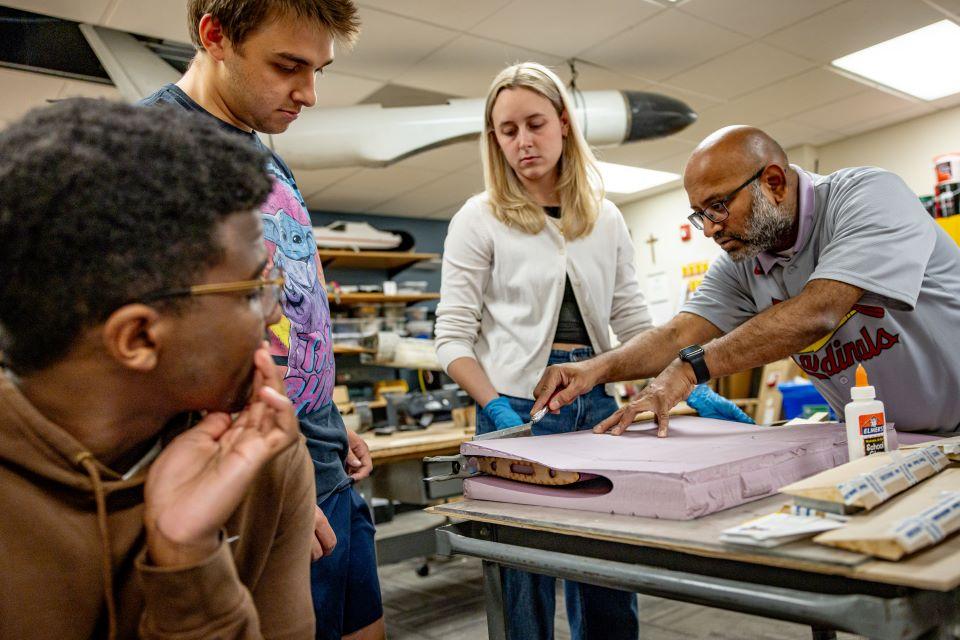 Srikanth Gururajan, Ph.D, right, works with students in the AirCRAFT Lab. Photo by Sarah Conroy.