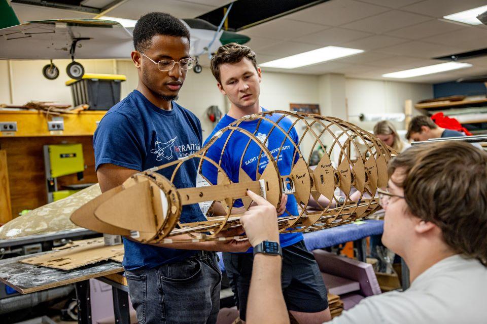 Chuka Okeke, pictured at left, and Ian Roudebush, center, work with Will Jameson in the AirCRAFT Lab. Photo by Sarah Conroy.