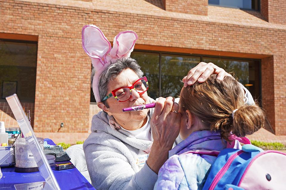 A young girl gets her face painted during the Easter Egg Hunt.