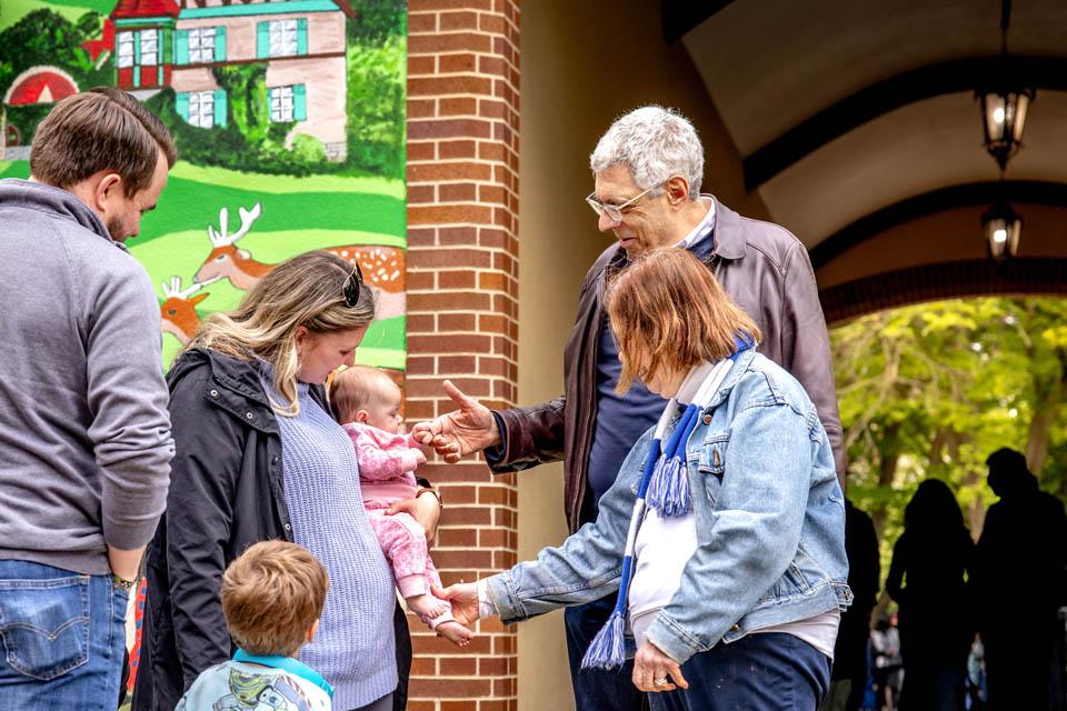 President Fred P. Pestello, Ph.D., and First Lady Fran Pestello, Ph.D., greet faculty and staff families during a celebration for the Pestellos with the SLU community at Grant’s Farm on April 27, 2025. Photo by Sarah Conroy.