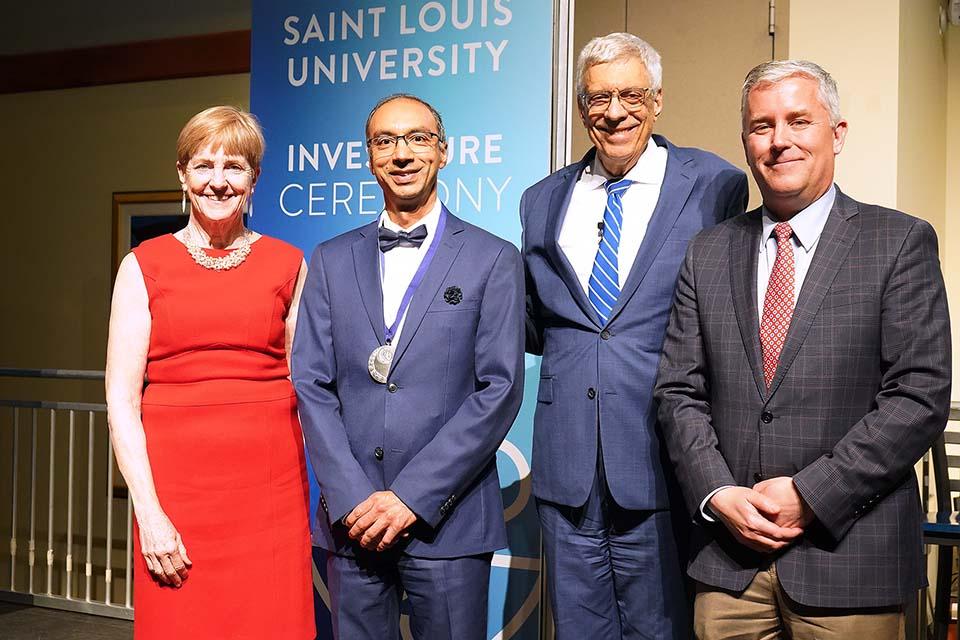 An honoree receives recognition on stage at the Investiture Ceremony. 