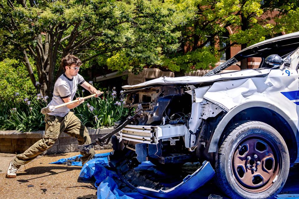 Students hit an old Public Safety car during the Destress with DPS event on May 6, 2025.
Photo by Sarah Conroy.