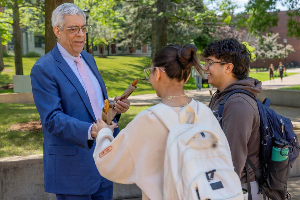 President Fred P. Pestello, Ph.D., passes out pretzels to students before the start of final exams on May 6, 2025. Photo by Sarah Conroy.