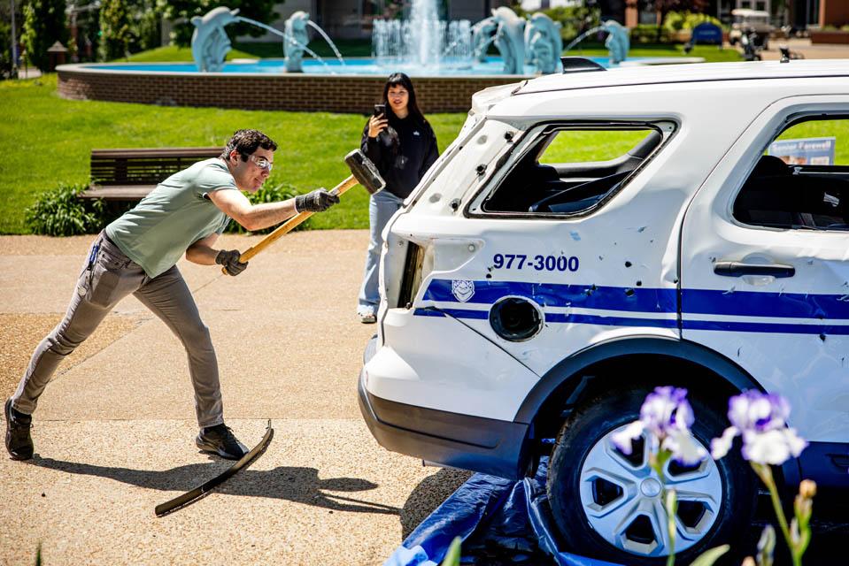 Students hit an old Public Safety car during the Destress with DPS event on May 6, 2025.
Photo by Sarah Conroy.
