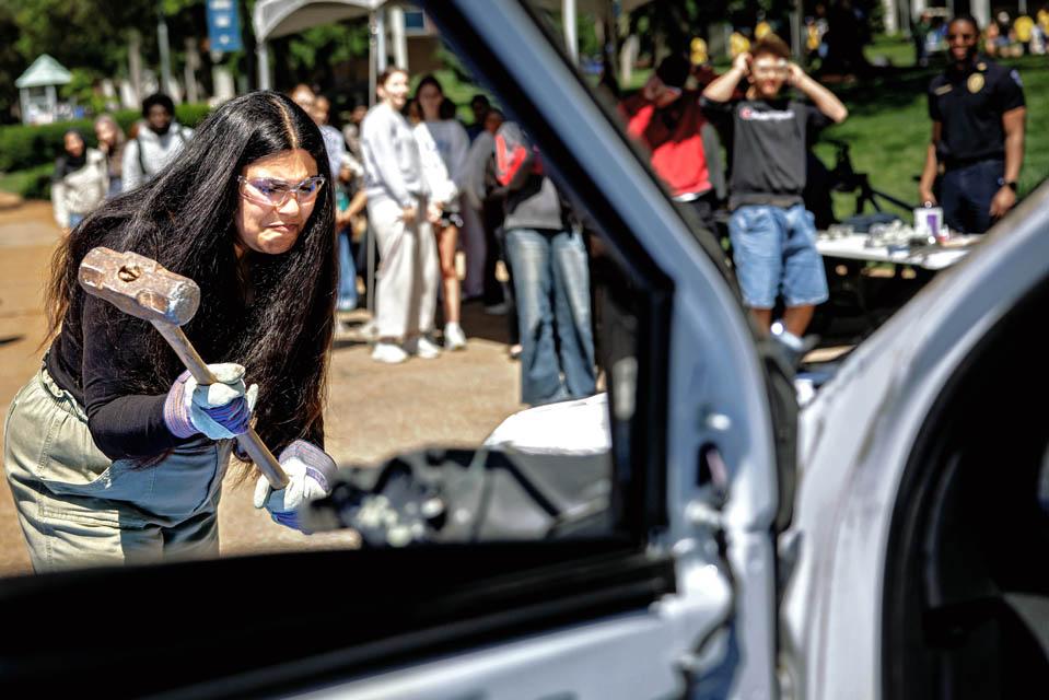 Students hit an old Public Safety car during the Destress with DPS event on May 6, 2025.
Photo by Sarah Conroy.