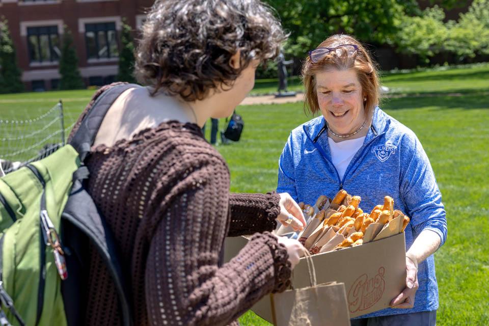 First Lady Fran Pesetllo, Ph.D., passes out pretzels on May 6, 2025. Photo by Sarah Conroy.