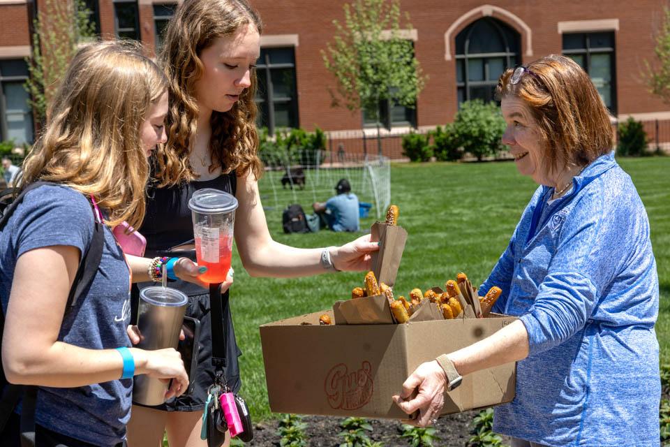 First Lady Fran Pesetllo, Ph.D., passes out pretzels on May 6, 2025. Photo by Sarah Conroy.