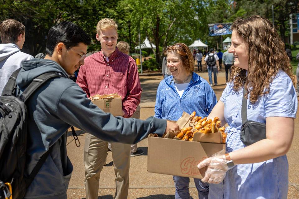 First Lady Fran Pesetllo, Ph.D., passes out pretzels on May 6, 2025. Photo by Sarah Conroy.