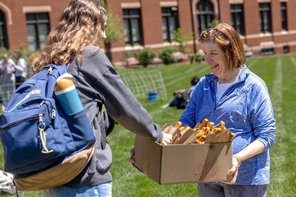First Lady Fran Pesetllo, Ph.D., passes out pretzels on May 6, 2025. Photo by Sarah Conroy.
