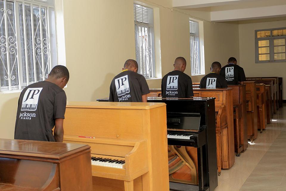 Students at the Bukalasa Minor Seminary play their Jackson pianos for the very first time this summer. Submitted photo.