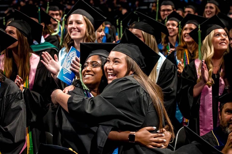 Graduates embrace during Commencement on May 17, 2025. Photo by Sarah Conroy.