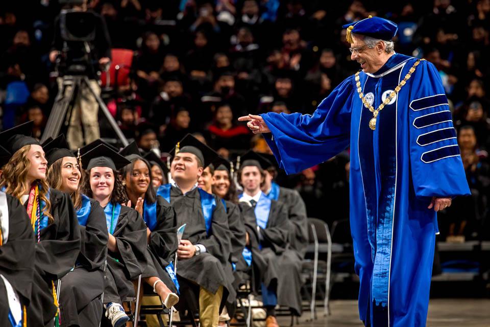 President Fred P. Pestello, Ph.D., walks to the stage at Commencement for the last time on May 17, 2025. Photo by Sarah Conroy.

