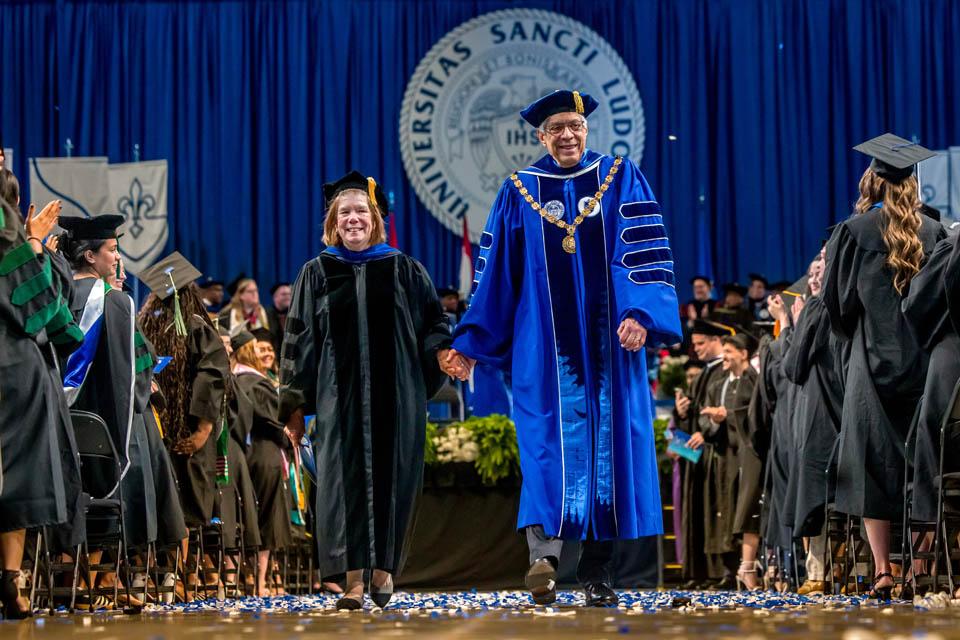 President Fred P. Pestello, Ph.D., and First Lady Fran Pestello, Ph.D., exit Commencement for the last time on May 17, 2025. Photo by Sarah Conroy.