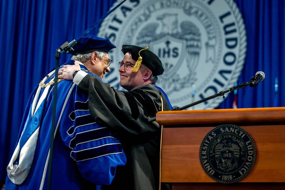 Provost Michael Lewis, Ph.D., embraces President Fred P. Pestello, Ph.D., before Pestello's address during Commencement on May 17, 2025. Photo by Sarah Conroy.