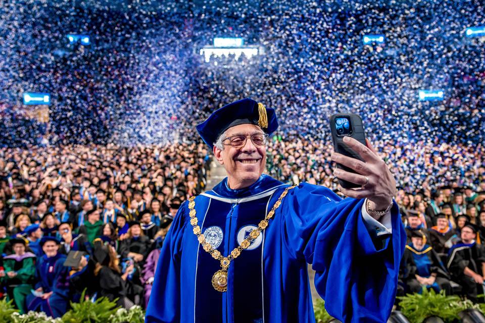 President Fred P. Pestello, Ph.D., takes a selfie as confetti falls during Commencement on May 17, 2025. Photo by Sarah Conroy.