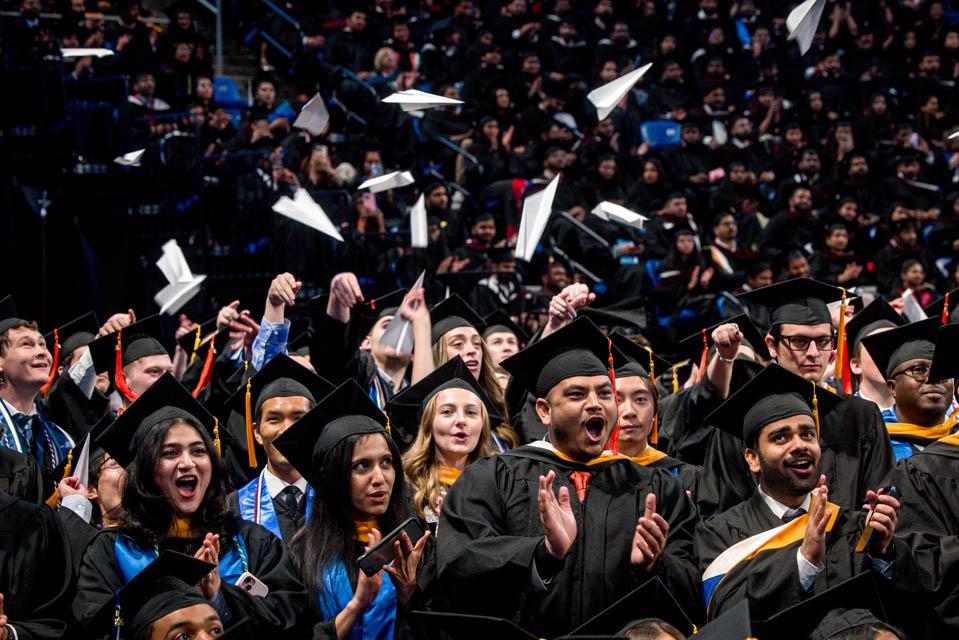 Graduates from the School of Science and Engineering throw paper airplanes during Commencement on May 17, 2025. Photo by Sarah Conroy.