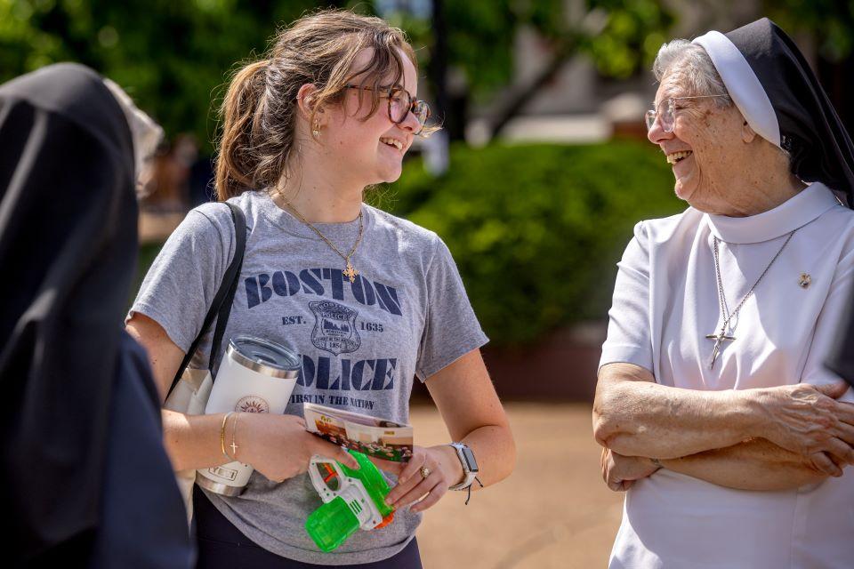 A SLU student talks to nuns during a vocation fair on campus April 25. Photo by Sarah Conroy.
