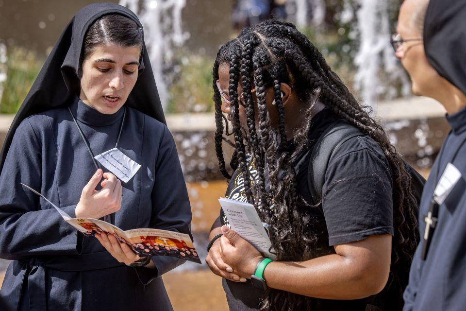 A SLU student talks to nuns during a vocation fair on campus April 25. Photo by Sarah Conroy.