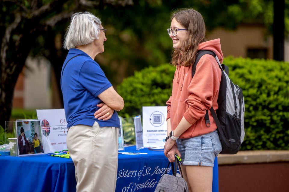 A SLU student talks to a Sister of St. Joseph of Carondelet during a vocation fair on campus April 25. Photo by Sarah Conroy.