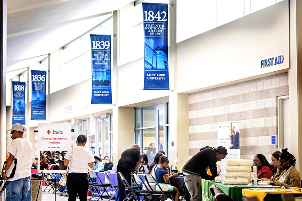 Survivors of the May 16 tornado receive support at the Disaster Assistance Center in Chaifetz Arena on June 17, 2025. The DAC, which serves as a central space for tornado-affected residents to connect with agencies and resources, is a partnership between the City of St. Louis, Missouri State Emergency Management Agency and SLU. Photo by Sarah Conroy.