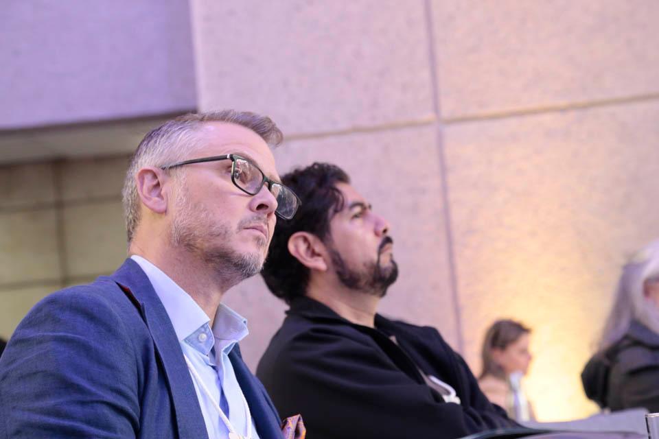 William Johnson, J.D., rector of the Madrid campus (left), listens during the pre-conference session, “Democracy in Crisis.” Photo courtesy of IAJU.
