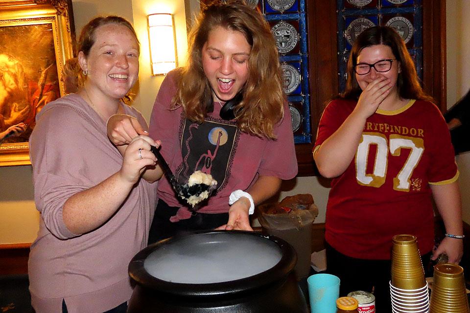 SLUpefy officers make sure the Butter Beer bubbles at the club's Sorting Hat Ceremony.