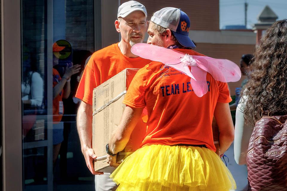 President Edward Feser, Ph.D.,helps an Oriflamme member lift a refrigerator during move-in on August 15, 2025. Photo by Sarah Conroy.
