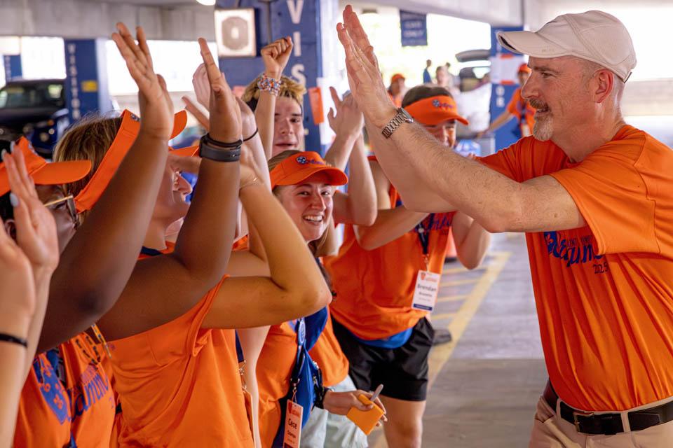 President Edward Feser, Ph.D., high-fives Oriflamme members during move-in on Friday, Aug. 15, 2025. Photo by Sarah Conroy.