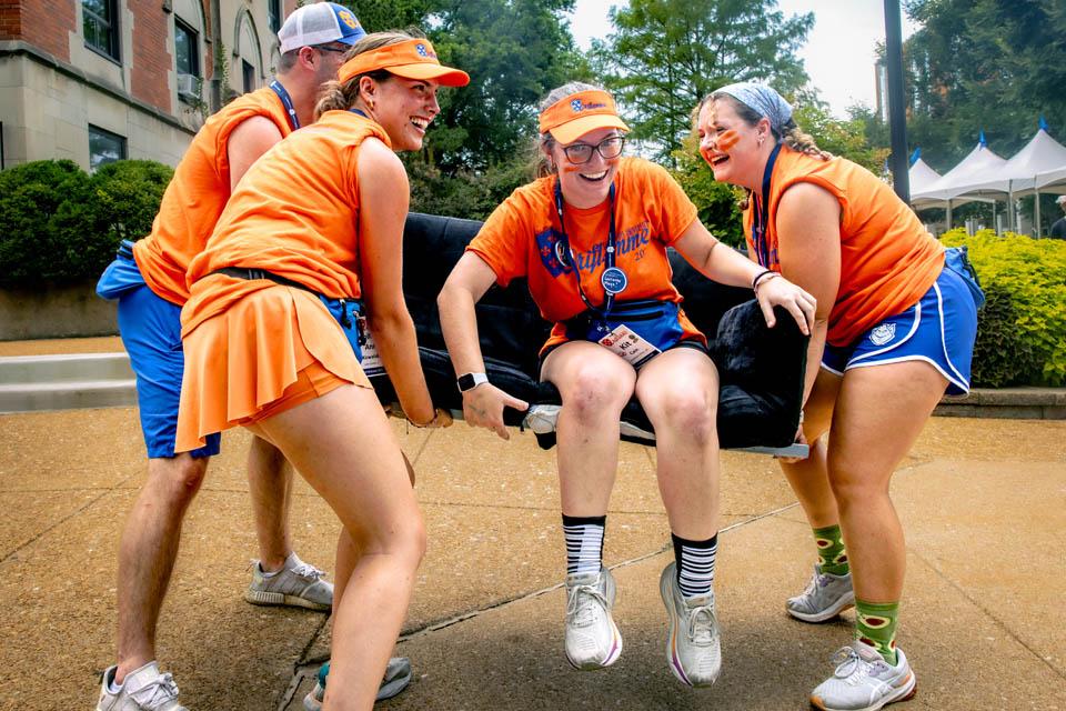 Oriflamme members lift a couch during move-in on Friday, Aug. 15, 2025. Photo by Sarah Conroy. 

