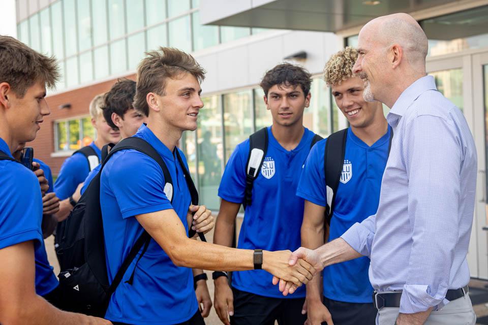President Edward Feser, Ph.D., greets student athletes after Convocation on Aug. 16, 2025. Photo by Sarah Conroy.
