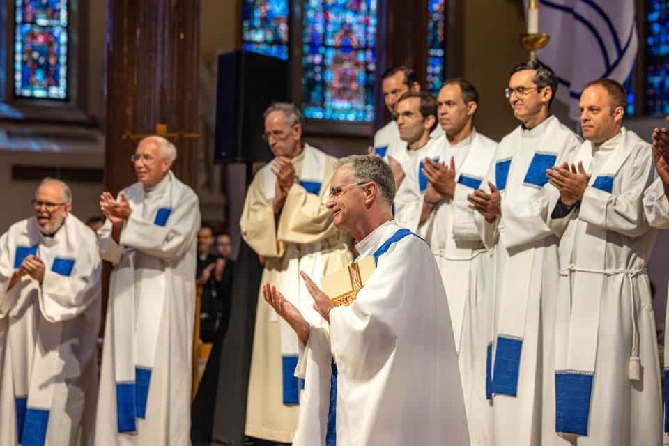 A group of priests applaud Edward Feser, Ph.D.