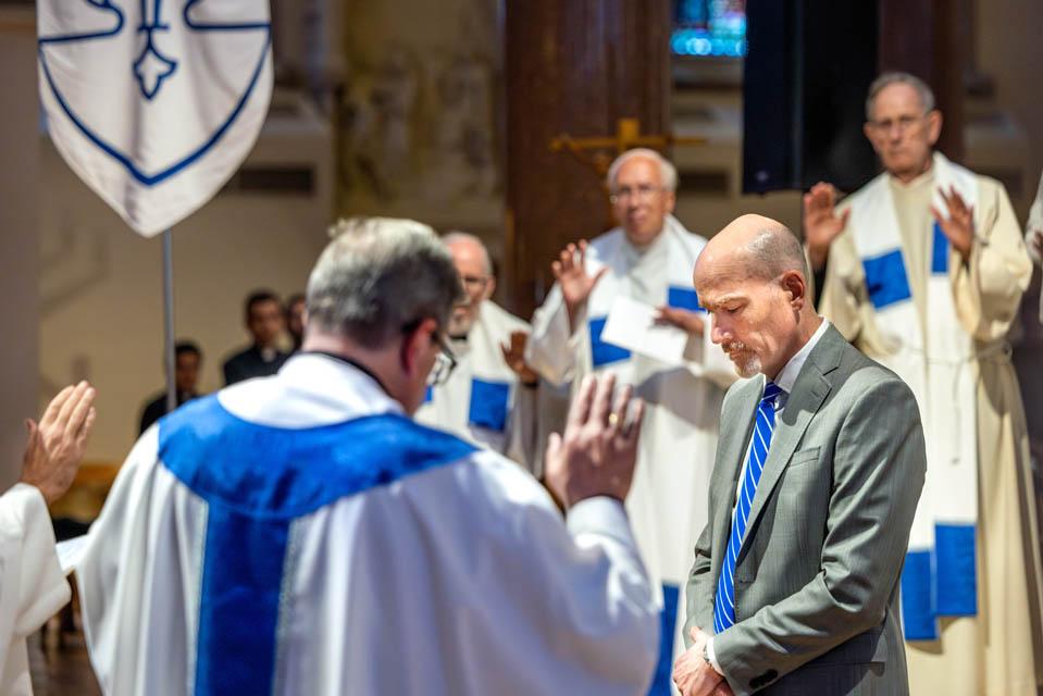Priests pray over SLU's new President Edward Feser, Ph.D.