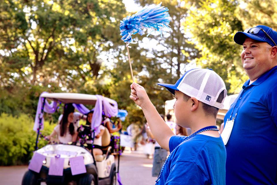Alumni and families watch the Homecoming and Family Weekend Golf Cart Parade on Sept. 27, 2025. Photo by Sarah Conroy. 