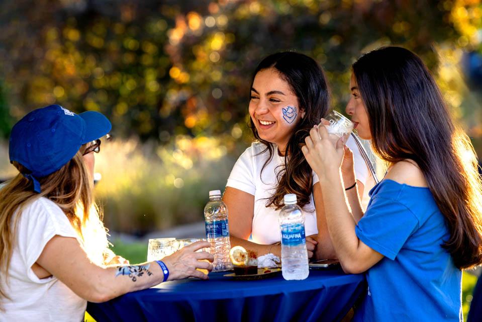 Attendees chat at the sideline reception during the Homecoming and Family Weekend on Sept. 27, 2025. Photo by Sarah Conroy. 