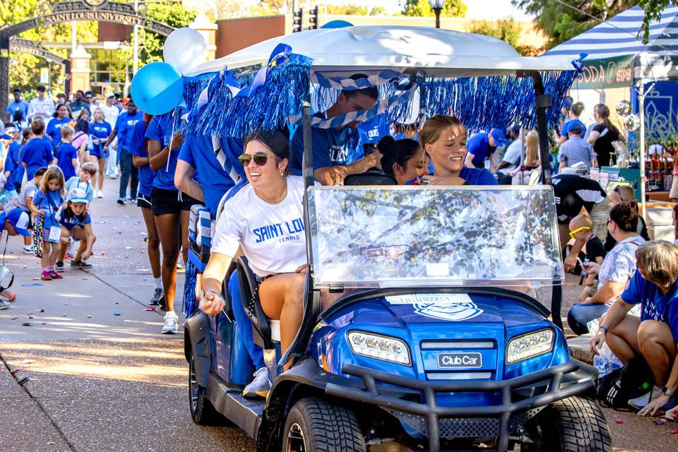 SLU athletes toss candy during the Homecoming and Family Weekend Golf Cart Parade on Sept. 27, 2025. Photo by Sarah Conroy. 