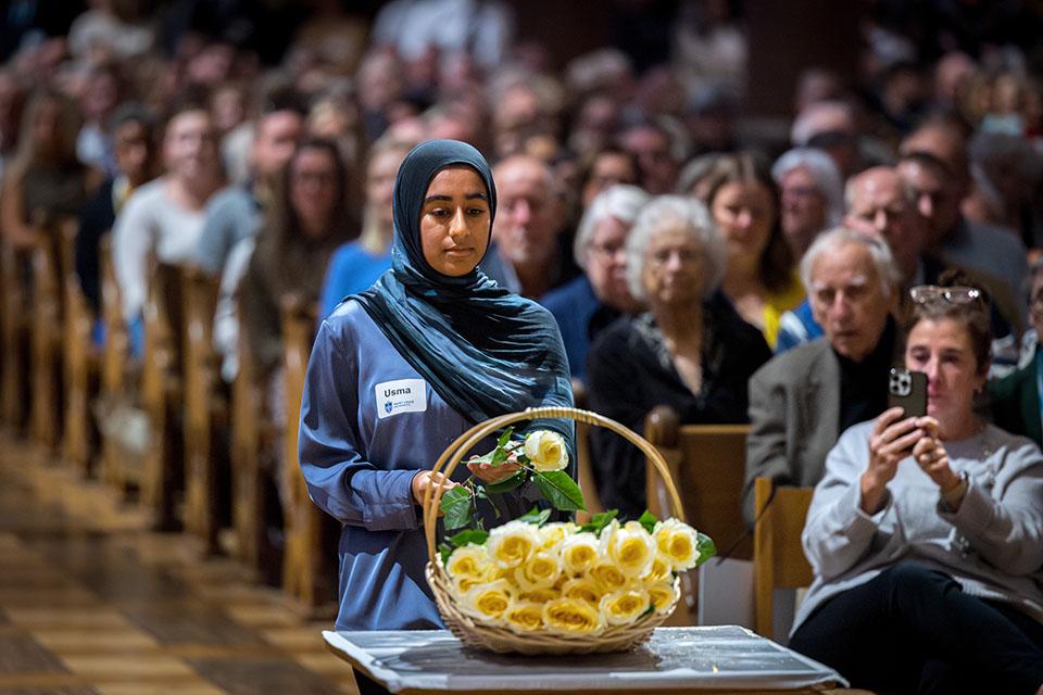 School of Medicine students offer yellow roses in memory of those who donated their bodies to the Gift Body program during the Interfaith Memorial Service on Oct. 24, 2025.