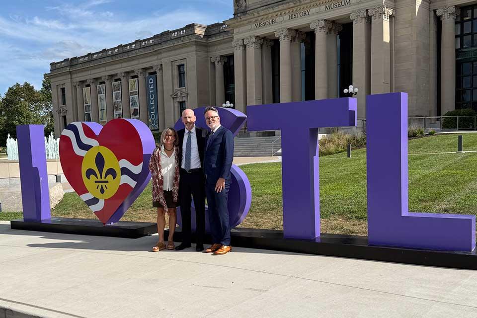 The Fesers with Missouri Historical Society CEO and SLU alumnus Jody Sowell outside of the Missouri History Museum on Aug. 25, 2025.
