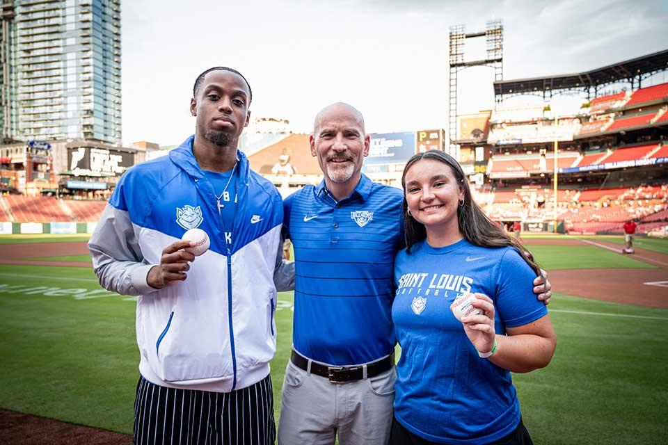 President Feser joins SLU students to throw out the first pitch at the St. Louis Cardinals' game on Aug. 27, 2025.