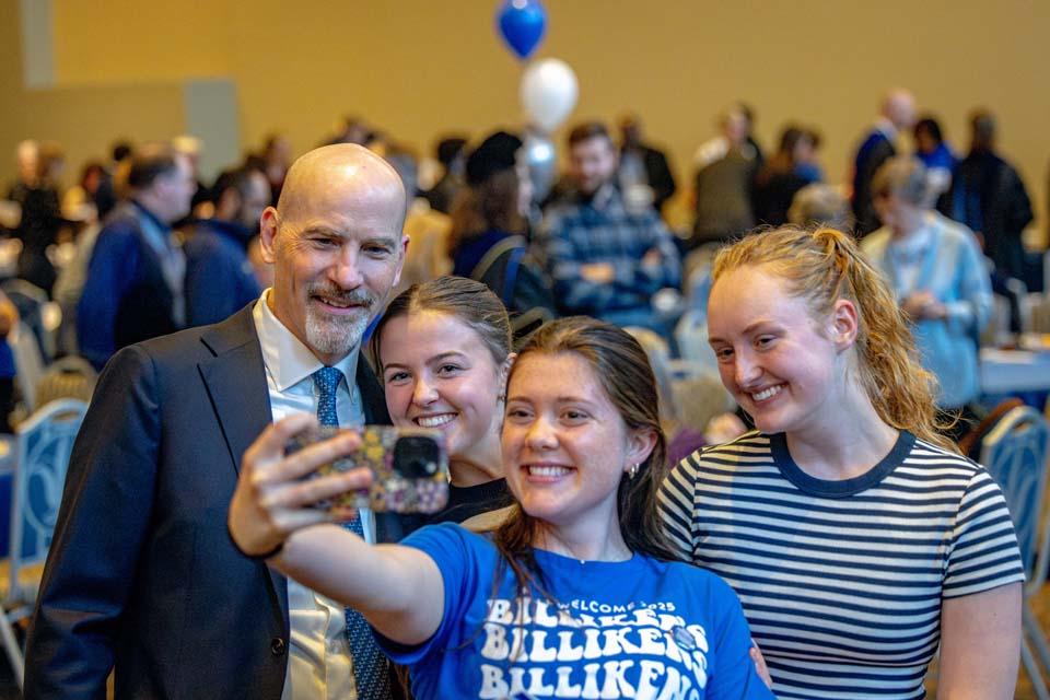 President Edward Feser, Ph.D., takes a selfie with students at a luncheon following the Presidential Inauguration of President Edward Feser, Ph.D., on Nov. 5, 2025. Photo by Sarah Conroy.