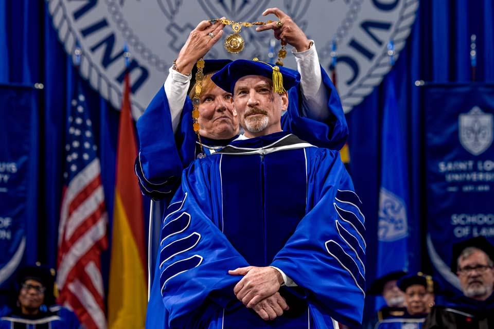 Vice Chair of the Board of Trustees Marian “Bo” Mehan (’74, ’82) puts the chain of office on Edward Feser, Ph.D., at the Nov. 5, 2025, inauguration ceremony. Photo by Sarah Conroy.