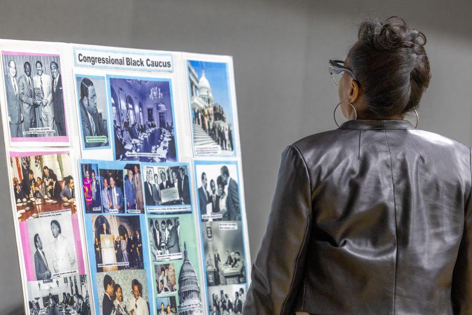 Tenth Ward Alderwoman Shameem Clark Hubbard looks at the poster presentation during the William L. Clay Sr. Institute of Civic Engagement and Economic Justice Open House on November 11, 2025. Photo by Sarah Conroy. 