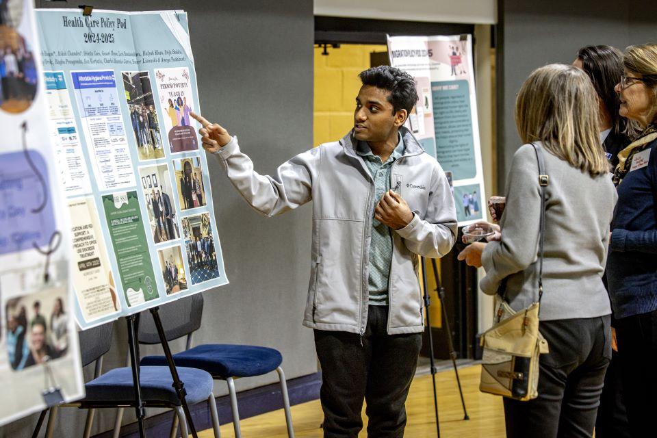 Attendees look at posters before the William L. Clay Sr. Institute of Civic Engagement and Economic Justice Open House on November 11, 2025. Photo by Sarah Conroy. 
