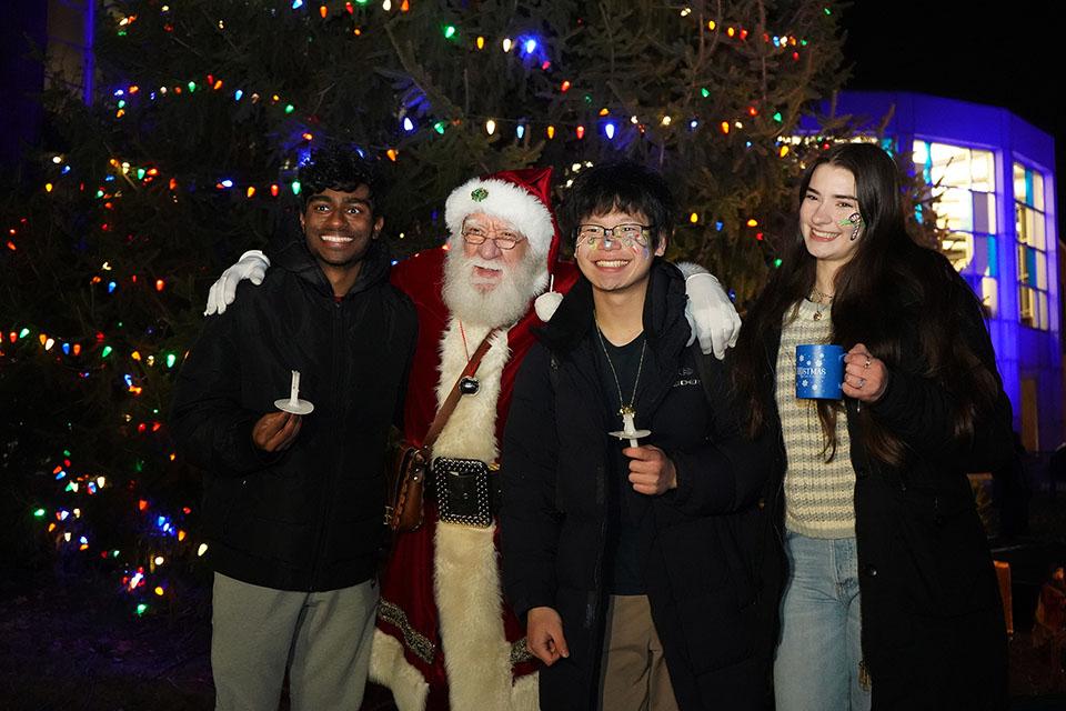 Santa poses for photos with attendees during Christmas on the Quad on Dec. 6, 2025. Photo by Megan Favignano Mansouri.
