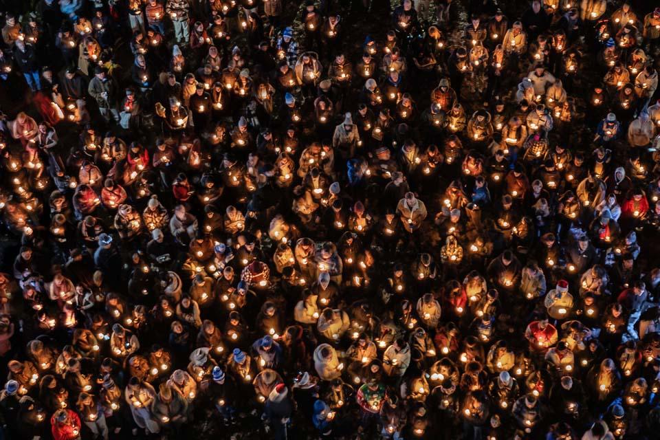 Attendees gather on the quad with candles for the tree lighting during Christmas on the Quad on Dec. 6, 2025. Photo by Sarah Conroy.