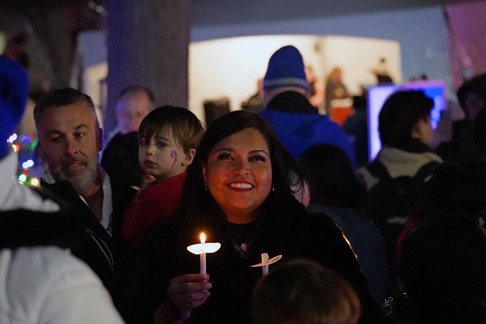 Attendees gather with candles for the tree blessing during Christmas on the Quad on Dec. 6, 2025. Photo by Megan Favignano Mansouri.